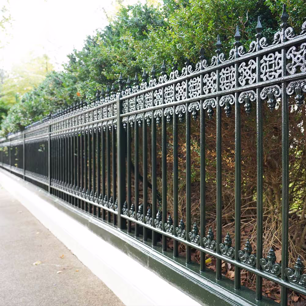 A long, ornate heritage cast-iron railing that has been meticulously restored and repainted in a traditional dark green as part of a cyclical decorations programme.