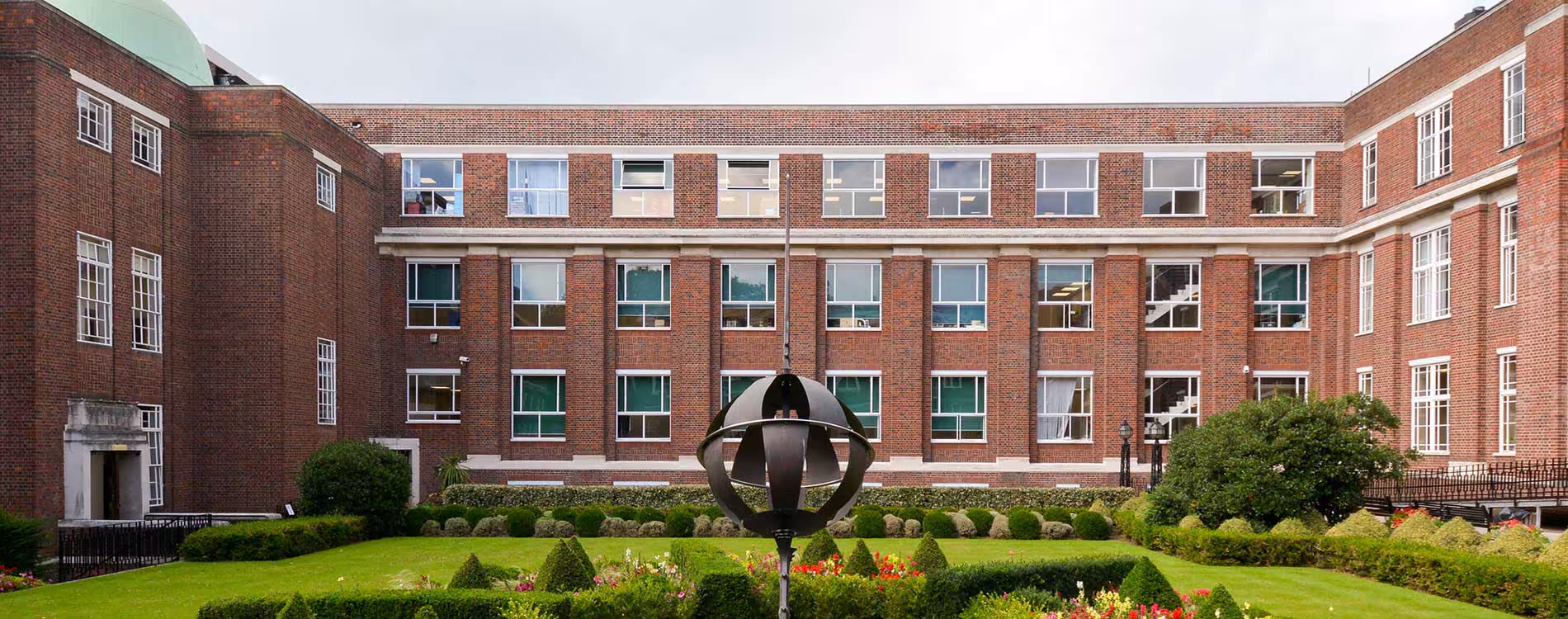 Wide shot of Regent's University London with restored Portland stone facade, fresh paintwork, and new signage after the renovation programme.