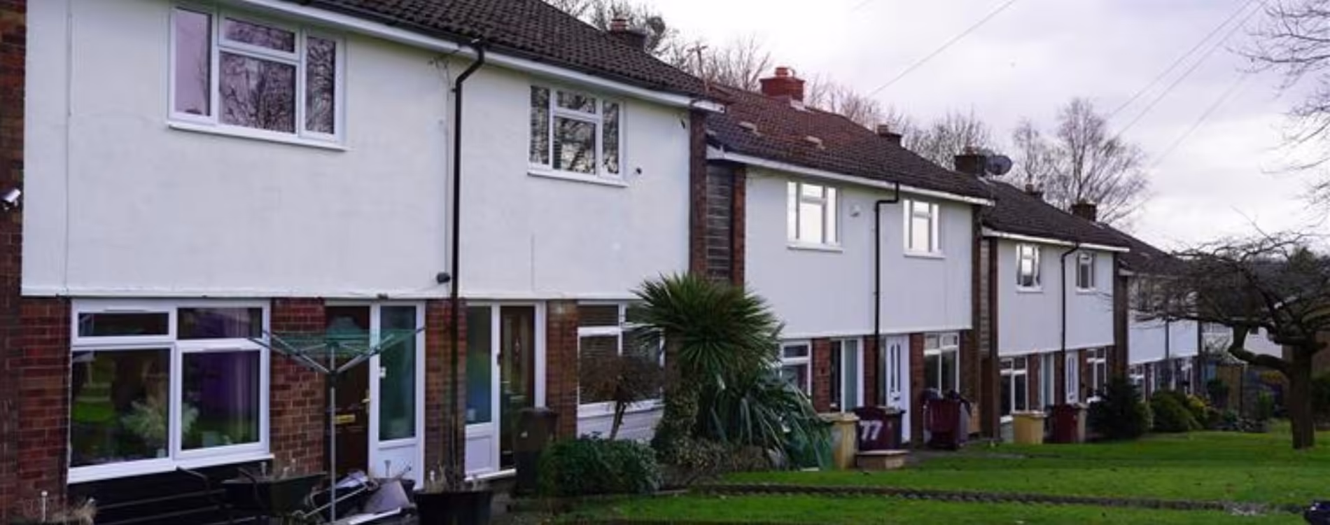 A row of terraced houses with freshly rendered white upper floors, showcasing the results of a planned and major reactive works programme.