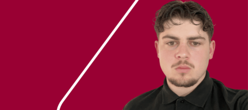 boy standing in front of a red background wearing an Axis t-shirt