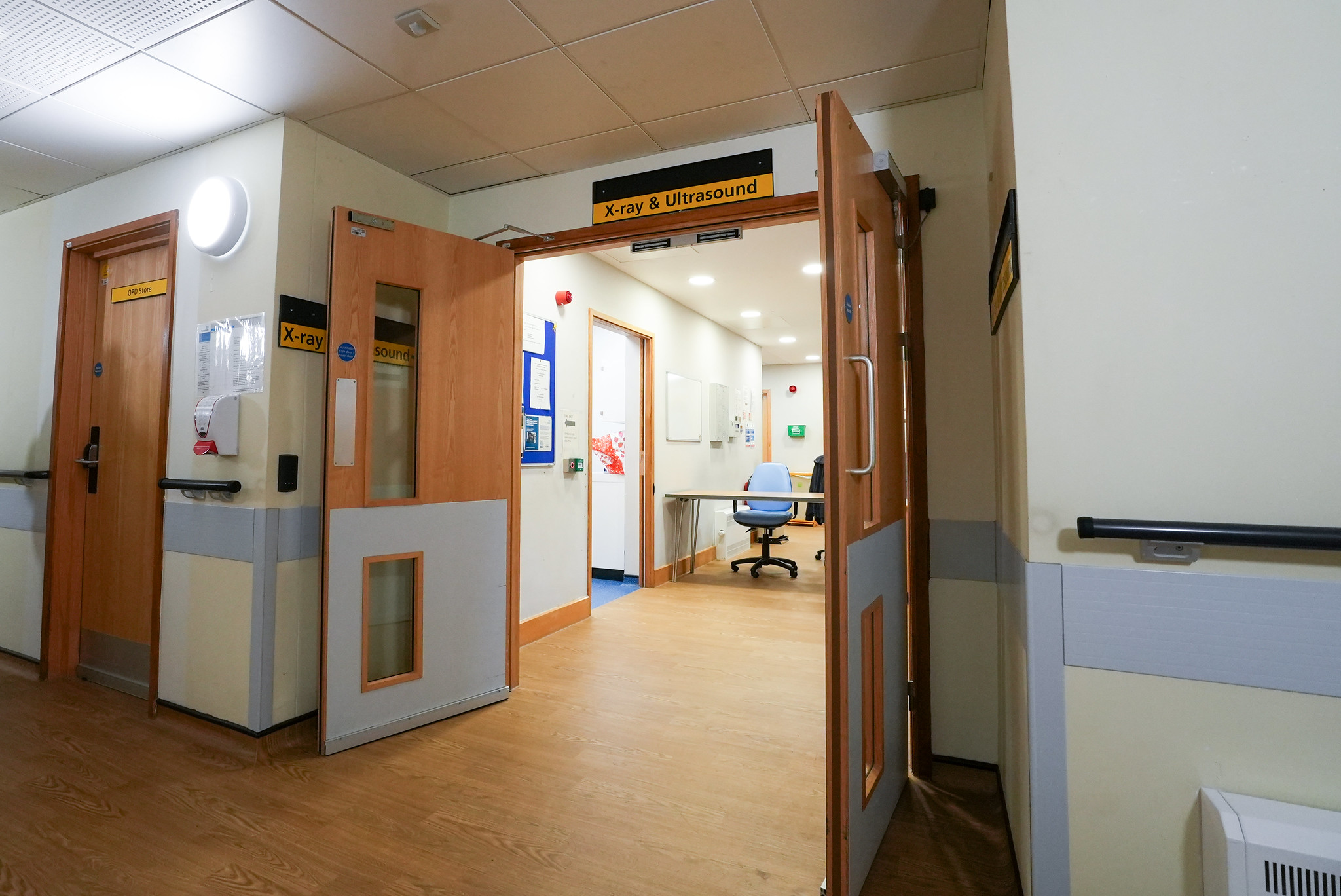 hospital corridor showing open fire door within an NHS facility