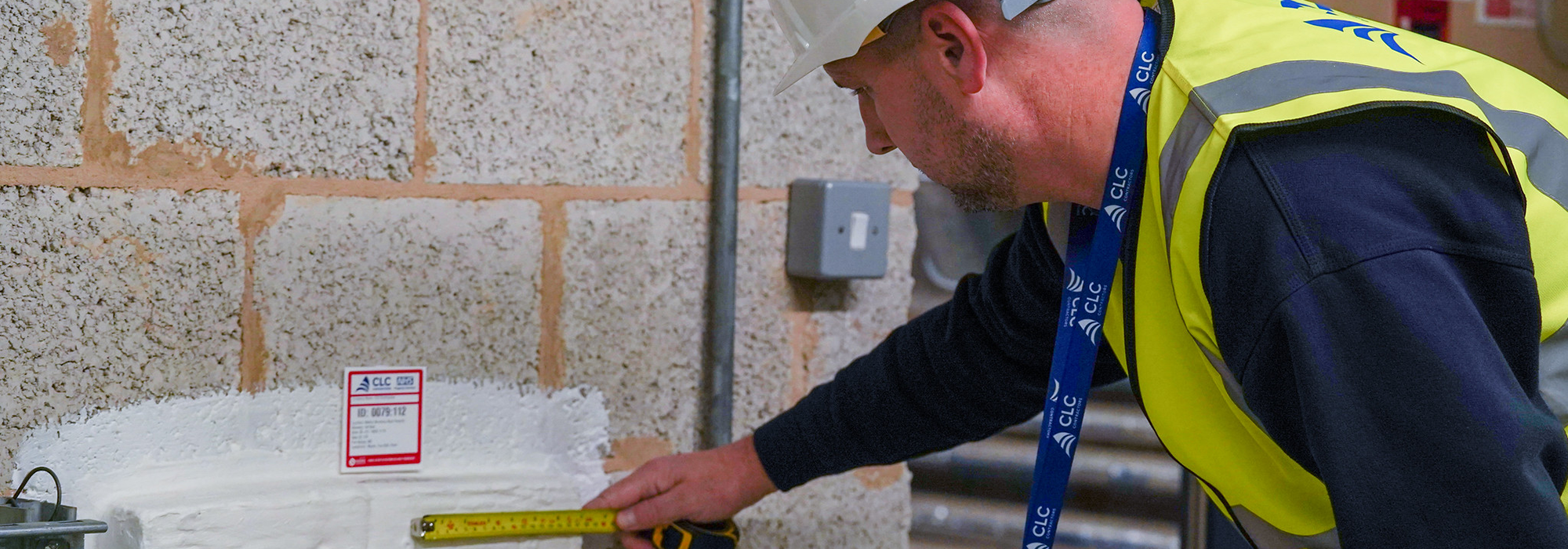 operative completing passive fire works in high vis jacket with a white safety hat