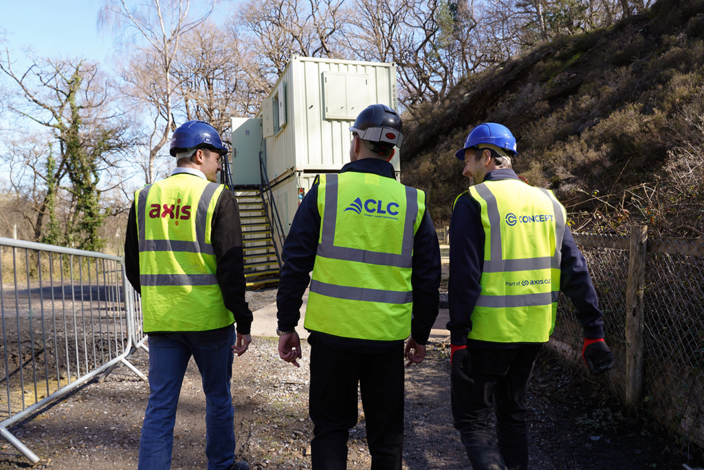 three operatives on site in high vis and blue hard hats showing