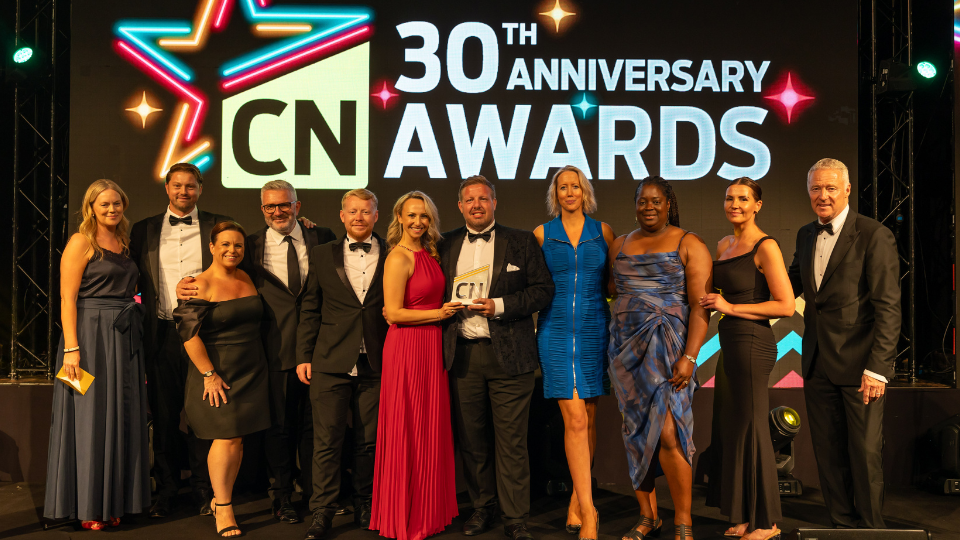 Awards celebration - group of people under banner saying 30th Anniversary CN Awards
